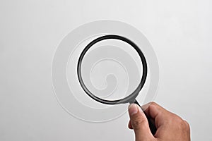 Hand holding Magnifying Glass