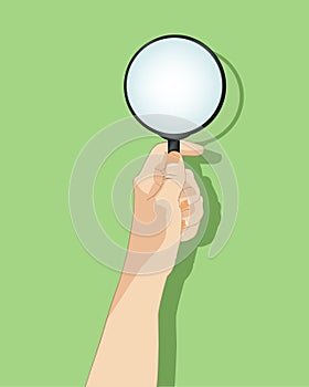 Hand holding magnifying glass