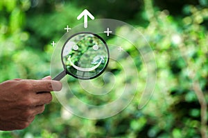 Hand holding a magnifying glass highlighting a happy smile. Concept of positive thinking, mental health,