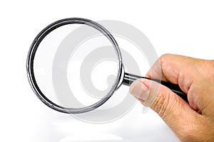Hand holding a magnifying glass isolate on white background and make with paths