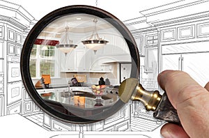 Hand Holding Magnifying Glass Revealing Finished Kitchen Build Over Drawing