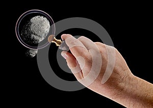 Hand Holding Magnifying Glass Viewing A Fingerprint on a Black Background