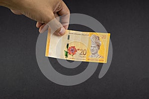 Hand holding Malaysia Ringgit MYR Currency Bank Notes. photo