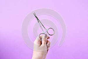 Hand holding Manicure and pedicure tools on pink background. Nail salon banner design template. Beauty treatment concept