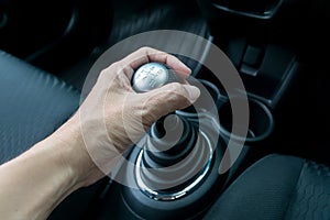 Hand holding manual transmission