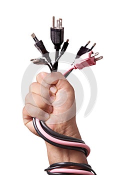 Hand holding Many home use plugs unplugged into electric power