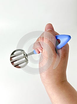 Hand holding mash potato ricer