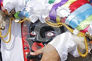 Hand holding a mask of the Mexican culture purepecha