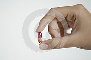Hand holding medical drug capsule