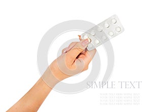 Hand holding medical drugs - full silver leaflet of white pills