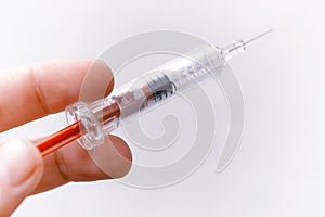Hand holding a medical syringe. Vaccine concept.