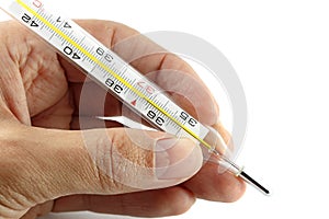 A hand holding medical thermometer