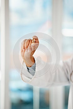 Hand holding medicine, tablet and healthcare doctor holding a pill for remedy, cure for sickness and medication for good