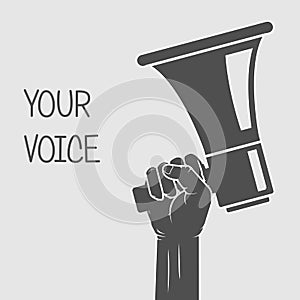 Hand holding megaphone - voice and opinion concept