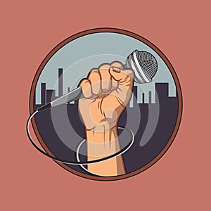 Hand holding a microphone in a fist, background