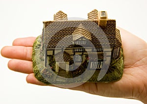 Hand holding minature of house photo