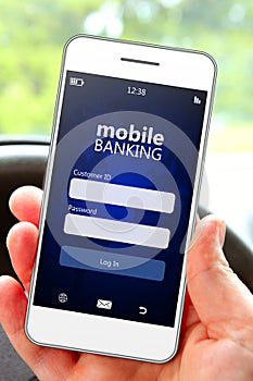 Hand holding mobile phone with banking log in page