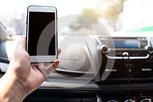 Hand holding mobile phone in car with Clipping path. man sitting in car holding phone