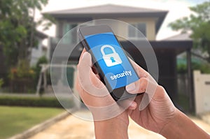 Hand holding mobile phone with concept technology home security