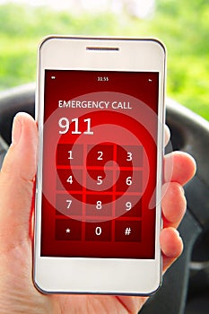 Hand holding mobile phone with emergency number 911