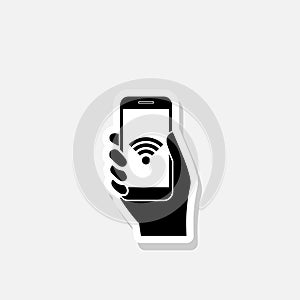 Hand holding mobile phone with free wifi sticker icon