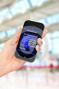 Hand holding mobile phone with mobile boarding pass