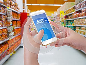 Hand holding mobile phone with Online shopping word