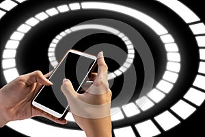 Hand holding mobile smart phone with blank screen on circular pattern technology background