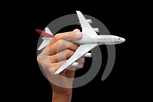Hand holding a model plane.
