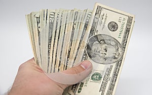 Hand holding money, american twenty dollars bills on a white background