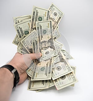 Hand holding money, american twenty dollars bills on a white background