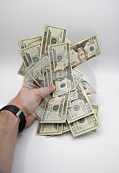 Hand holding money, american twenty dollars bills on a white background