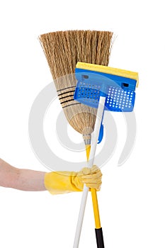 Hand holding a mop and a broom - Household chores