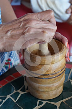 Hand holding mortar in kitchen