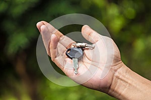 Hand holding motorcycle car key