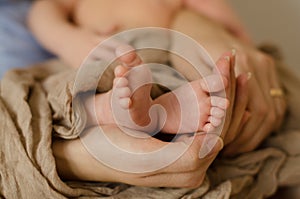 Hand holding newborn baby`s feet