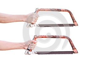 Hand holding old rusty bow saw isolated on white background