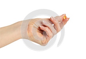 Hand holding omega capsule isolated on white background with clipping path.