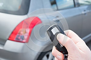 Hand holding one car alarm key with anti-theft