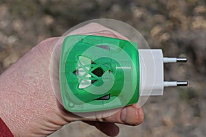 hand holding a one electric plastic fumigator