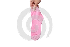 A hand holding one pink cotton organic sock isolated on white