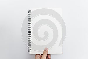 Hand holding opened blinder notebook, blank empty pages, on white background photo