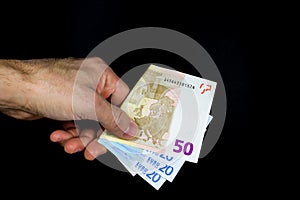 Hand holding out some banknotes