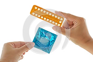 A hand holding package of condom in exchange with birth control