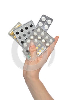 Hand holding packs of medicine aspirin painkiller tablet pills