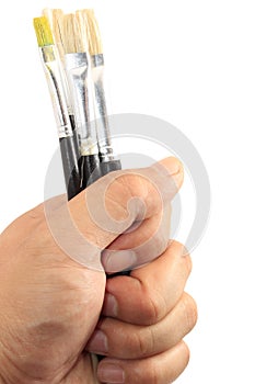 Hand holding paint brush