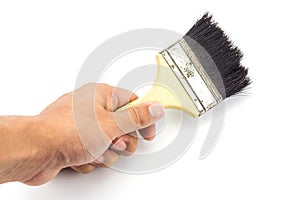 Hand holding paint brush