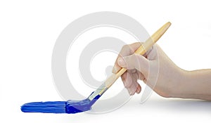 Hand holding paint brush blue