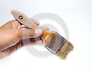 Hand holding paint brush isolated on white background