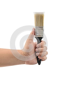 Hand holding paint brush with plastic black handle isolated
